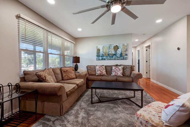 living room featuring recessed lighting, wood finished floors, a ceiling fan, and baseboards