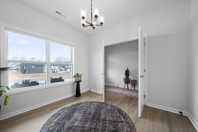 221 Wesson Dr, Clarksville, TN 37043 - interior space featuring baseboards, a notable chandelier, visible vents, and wood finished floors