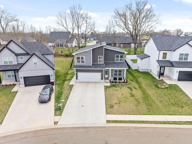 221 Wesson Dr, Clarksville, TN 37043 - view of front of home with an attached garage, a front lawn, concrete driveway, and a residential view