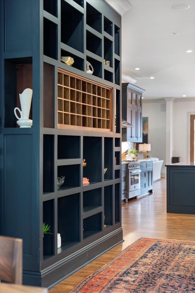 924 Gilmore Ave, Nashville, TN 37204 - room details featuring wall chimney range hood, wood finished floors, recessed lighting, and stainless steel range