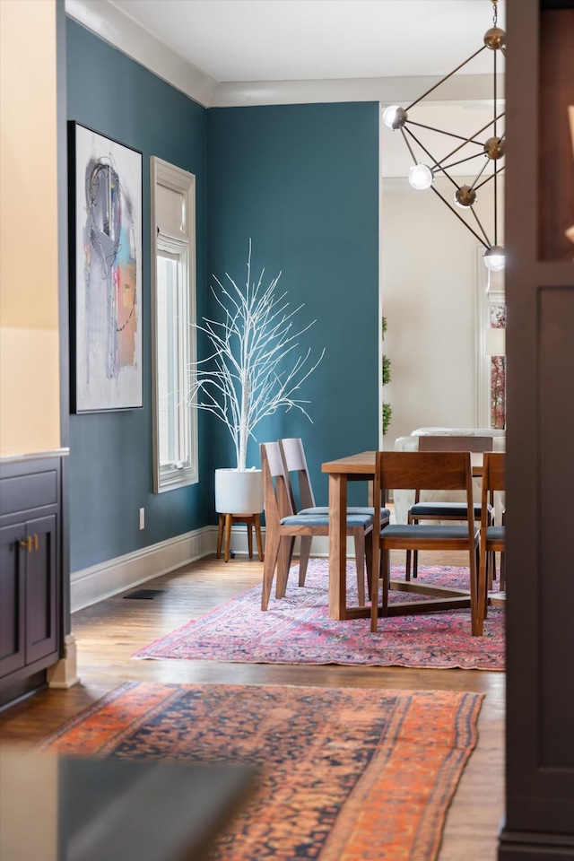 924 Gilmore Ave, Nashville, TN 37204 - dining space with baseboards, visible vents, wood finished floors, and a chandelier
