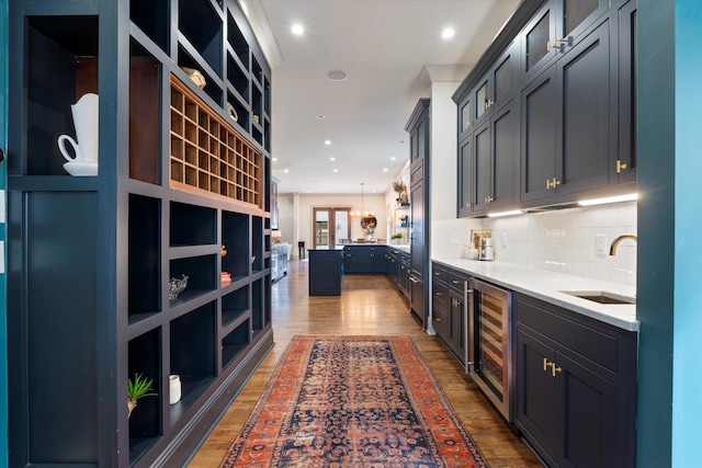 924 Gilmore Ave, Nashville, TN 37204 - bar featuring wine cooler, a sink, wood finished floors, decorative backsplash, and recessed lighting