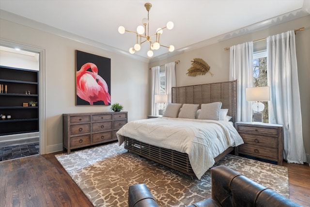 924 Gilmore Ave, Nashville, TN 37204 - bedroom with baseboards, wood finished floors, and a chandelier
