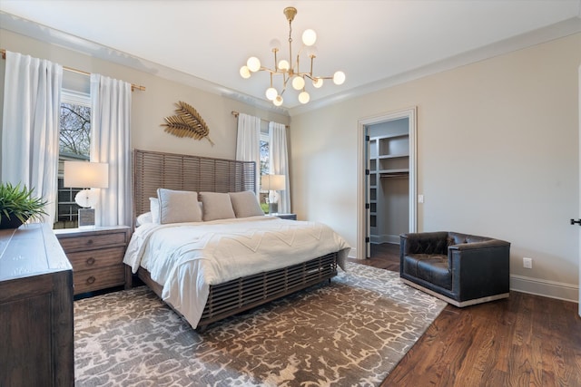 924 Gilmore Ave, Nashville, TN 37204 - bedroom with a walk in closet, baseboards, a chandelier, and wood finished floors