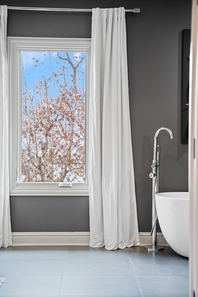 924 Gilmore Ave, Nashville, TN 37204 - bathroom with a freestanding bath, tile patterned flooring, and baseboards