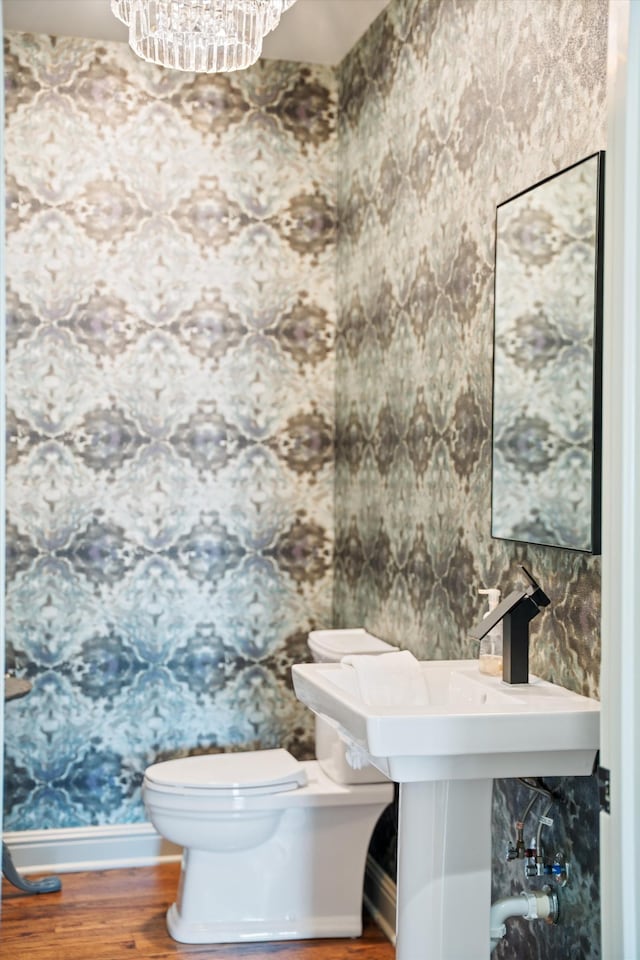 924 Gilmore Ave, Nashville, TN 37204 - half bath with baseboards, toilet, a chandelier, and wood finished floors
