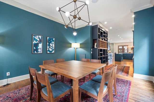924 Gilmore Ave, Nashville, TN 37204 - dining space with baseboards, wood finished floors, and a notable chandelier