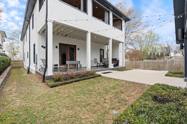 924 Gilmore Ave, Nashville, TN 37204 - back of property featuring french doors, a fenced backyard, a balcony, a patio, and a yard