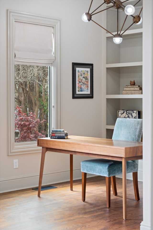 924 Gilmore Ave, Nashville, TN 37204 - office area featuring an inviting chandelier, baseboards, visible vents, built in features, and wood finished floors