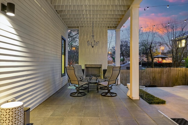 924 Gilmore Ave, Nashville, TN 37204 - patio terrace at dusk featuring a fireplace and fence