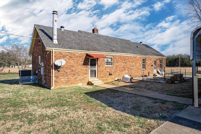 1985 Couchville Pike, Mount Juliet, TN 37122 - rear view of property with roof with shingles, entry steps, brick siding, a yard, and a chimney