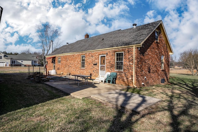 1985 Couchville Pike, Mount Juliet, TN 37122 - rear view of house featuring a lawn, entry steps, a patio area, brick siding, and a chimney