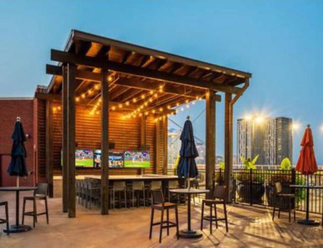 view of patio / terrace featuring fence and outdoor dry bar