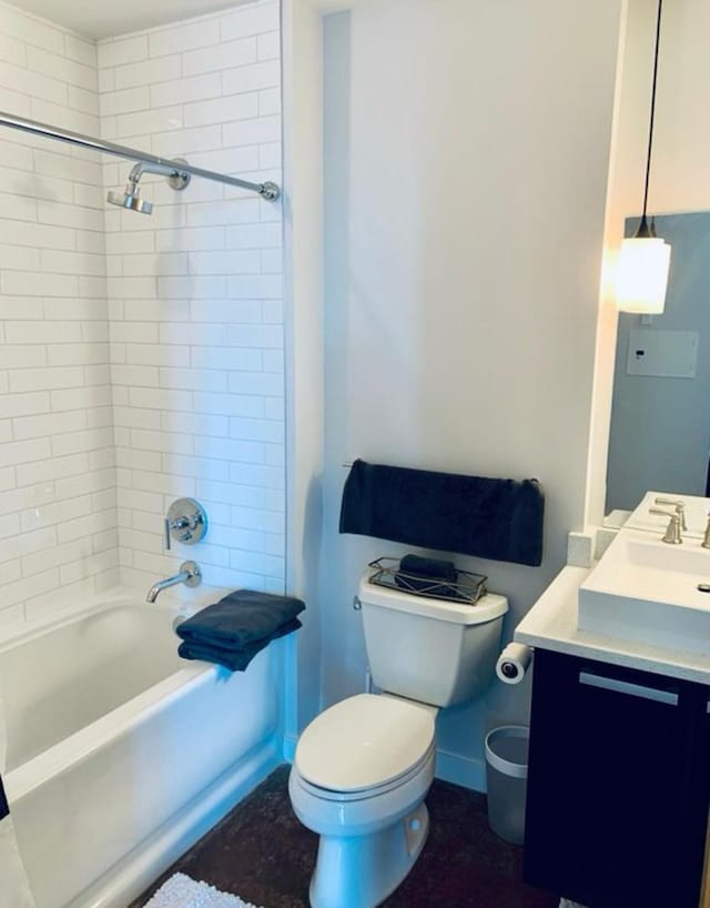 full bathroom featuring baseboards, toilet, vanity, and shower / washtub combination
