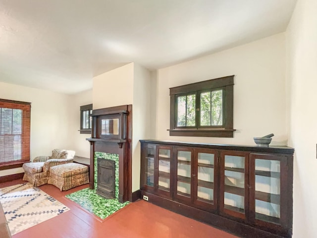 living area featuring wood finished floors and a tile fireplace