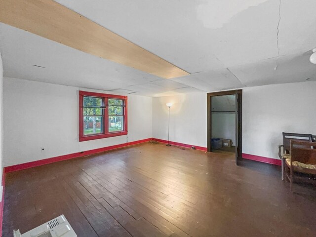 interior space featuring baseboards, visible vents, and wood-type flooring