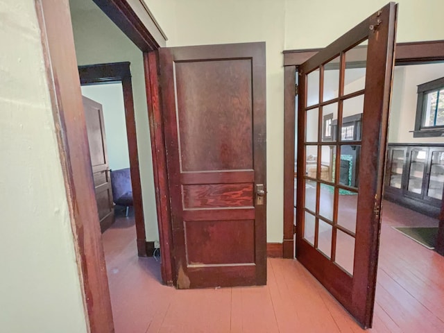hallway featuring french doors and wood finished floors