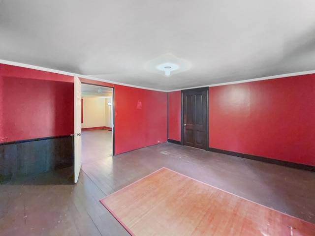 empty room featuring ornamental molding and wood finished floors