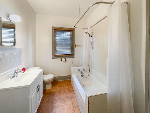 bathroom with toilet, shower / tub combo with curtain, backsplash, vanity, and baseboards