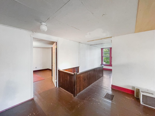 empty room featuring baseboards and visible vents