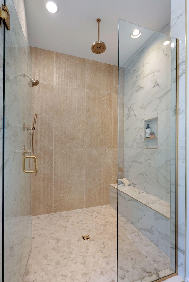 bathroom with a marble finish shower and recessed lighting