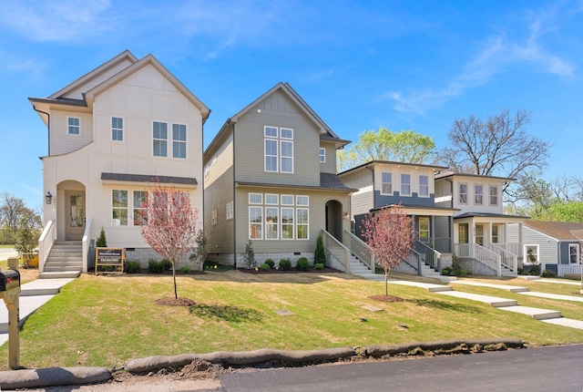 view of front facade featuring crawl space, board and batten siding, and a front lawn