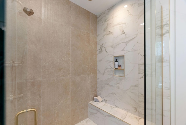 full bath with a marble finish shower