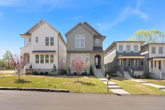 traditional home featuring crawl space, board and batten siding, and a front lawn