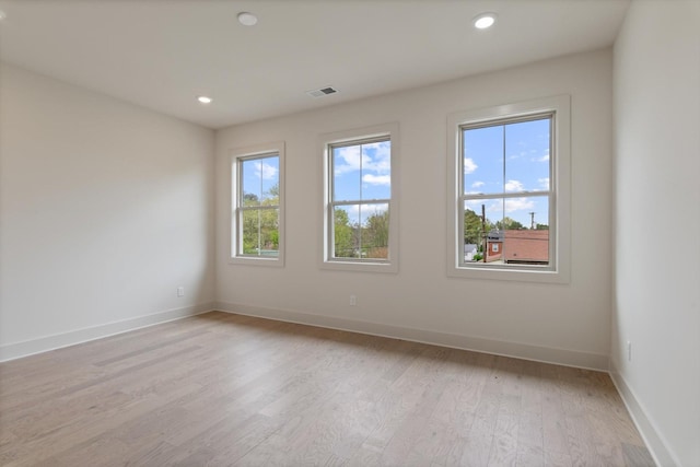 unfurnished room with recessed lighting, baseboards, visible vents, and light wood-style flooring