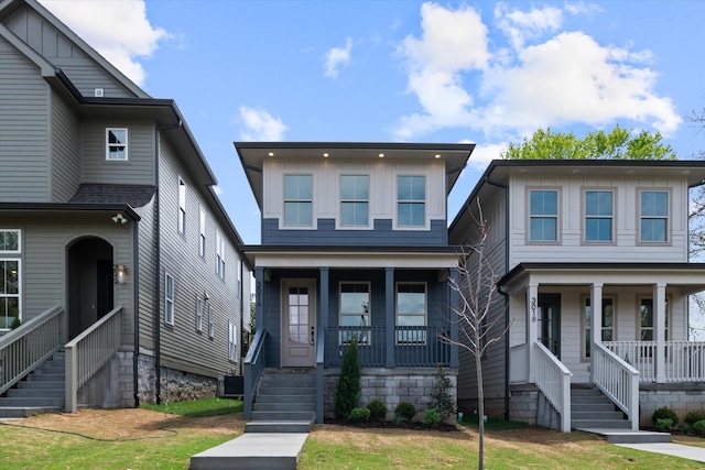 view of front of house with a porch, stairs, and board and batten siding