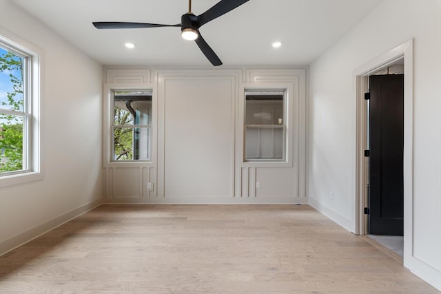 unfurnished bedroom with multiple windows, light wood finished floors, and recessed lighting