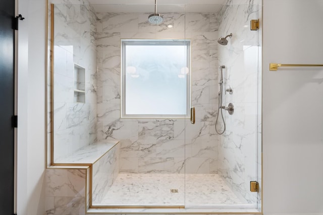 bathroom with a wealth of natural light and a marble finish shower
