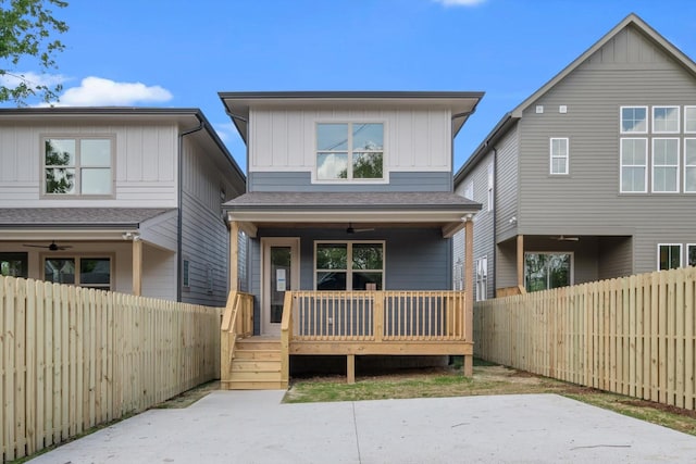 view of front of home featuring board and batten siding, a ceiling fan, and a fenced backyard