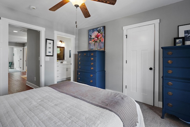 bedroom with ensuite bath, a sink, and a ceiling fan