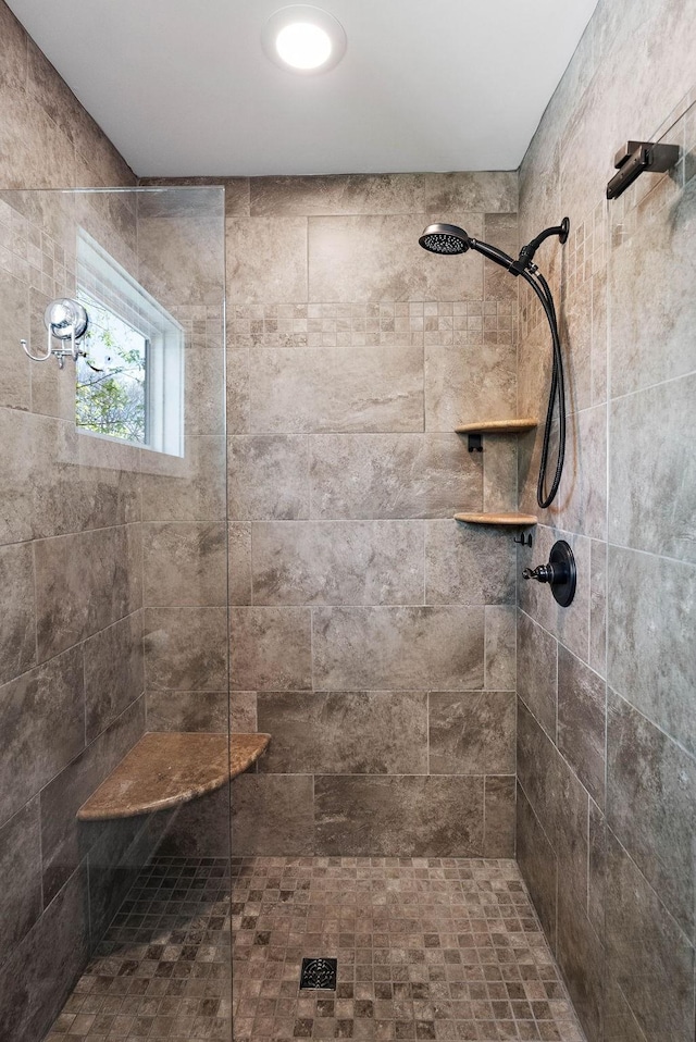 full bath with a tile shower