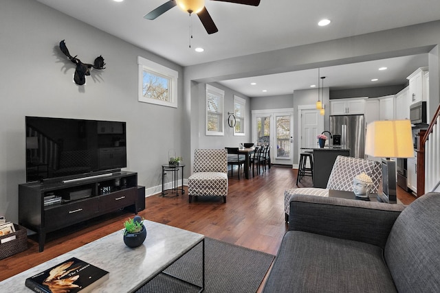 living area with baseboards, recessed lighting, dark wood-type flooring, and a ceiling fan
