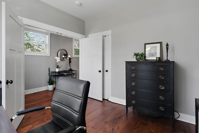 home office with dark wood-style flooring, baseboards, and visible vents