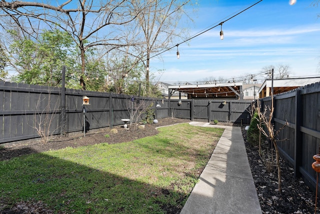 view of yard featuring a fenced backyard and a gate