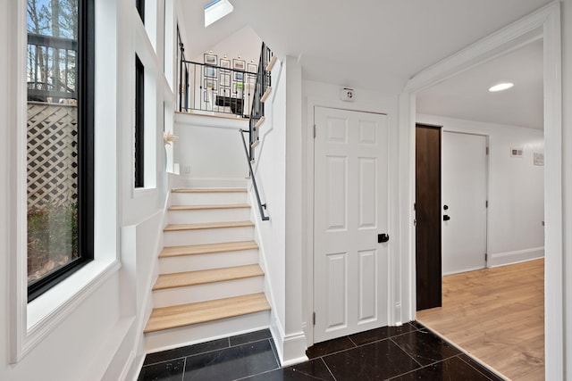 stairs featuring baseboards, a wealth of natural light, and recessed lighting