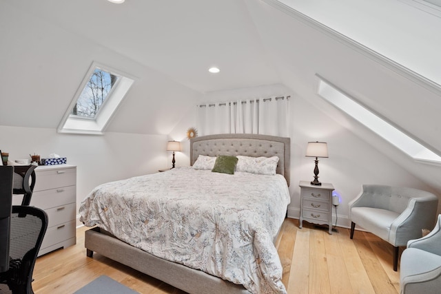 bedroom featuring vaulted ceiling with skylight, recessed lighting, and wood-type flooring