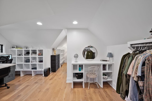walk in closet with lofted ceiling and light wood-style flooring