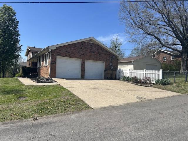 251 Sailboat Dr, Nashville, TN 37217 - view of side of home featuring an attached garage, brick siding, and driveway