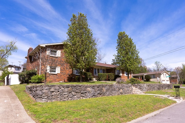 251 Sailboat Dr, Nashville, TN 37217 - view of front of house featuring brick siding, a front yard, and a chimney