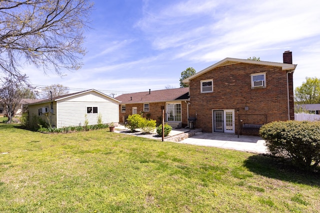 251 Sailboat Dr, Nashville, TN 37217 - rear view of house with brick siding, a patio area, a chimney, and a lawn