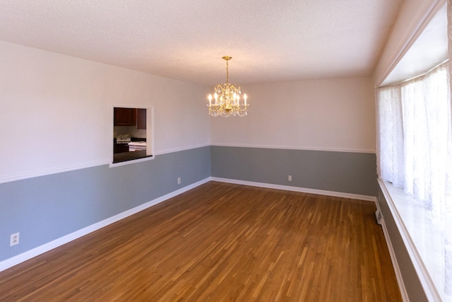 251 Sailboat Dr, Nashville, TN 37217 - spare room featuring wood finished floors, a chandelier, baseboards, and a textured ceiling