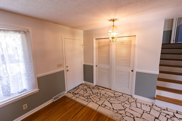 251 Sailboat Dr, Nashville, TN 37217 - foyer featuring stairway, a textured ceiling, a chandelier, light wood-type flooring, and baseboards