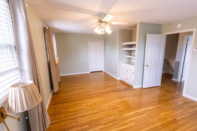 251 Sailboat Dr, Nashville, TN 37217 - spare room featuring light wood finished floors, baseboards, ceiling fan, a textured ceiling, and built in shelves