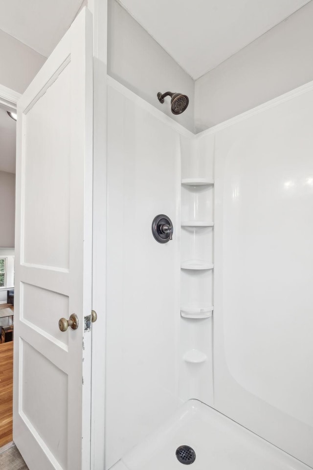 full bath featuring wood finished floors and walk in shower