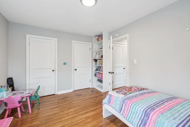 bedroom featuring baseboards and light wood-style flooring