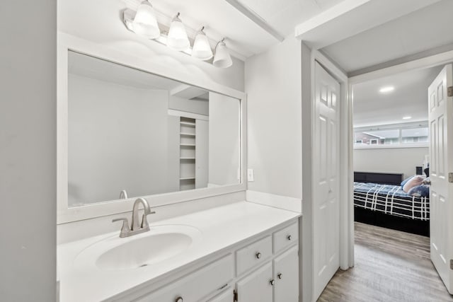 bathroom with wood finished floors and vanity